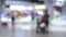 Blurred or defocused shopping mall interior with people walking at holiday