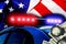 Blurred defocused silhouette of Road police patrol car with lightbar alarm emergency, dollar bills and handcuffs on American flag