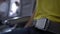 Blurred defocused view of asian woman fastening her seat belt inside airplane