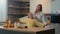 Blurred defocused view family mom and little daughter enjoy funny dance in kitchen together. Mother woman babysitter
