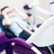 Blurred dental office. Tools are in the foreground. A boy with goggles in the dental chair