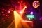 Blurred disco club with original laser color lights and disco ball - Defocused image - Concept of nightlife with cocktails, music