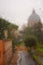 Blurred Dome of St Peters Basilica in Vatican City through raindrops on glass , Rome, Italy. Roman Catholic Church