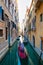 Blurred effect for a gondolier with tourists in a canal in Venice