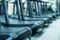 Blurred empty treadmills set in gym interior close