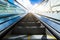 Blurred escalator toward modern skyscrapers