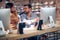 Blurred faces of young man and woman colleagues talking in front of table with desktop computer, in clothing store