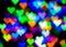 Blurred festive background with defocused colourful glitter formed a heart, bokeh in a shape of a heart. Original photographic