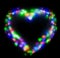 Blurred festive background with defocused colourful glitter formed a heart, bokeh in a shape of a heart. Original photographic