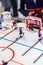 Blurred figure of a hockey player with a stick from a toy mini-hockey on a blurred background of a small goal