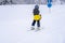 Blurred focus background. A boy lifting on the ski drag lift rope in blue sport outfit on the ski resort mountain do a