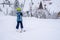 Blurred focus background. A girl lifting on the ski drag lift rope in blue sport outfit on the ski resort mountain do a