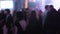 Blurred footage of crowded hall at night club with dancing young people around students hanging out at their prom night