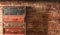 Blurred four vintage suitcases near brick wall background
