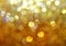 Blurred gold sparkling glitter lights graduated background