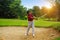 Blurred golfer playing golf in beautiful golf course in the evening golf course with sunshine