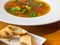 Blurred Homemade Hot soup with Vegetables, green vegearian soup, crackers with cheese, selective focus