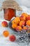 Blurred image of an apricot, a bunch of lavender and a jar of apricot jam in the background