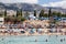 Blurred image of Cyprus beach full of people and Mediterranean sea with swimmers in water