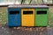 Blurred image of different colored trash cans for garbage sorting