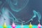 Blurred image of fading candles, blurry smoke, blue background. Holidays, Birthday concept. Small colorful melted candles.