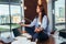 Blurred image of female student meditating on desk in classroom calming mind with her hand in focus