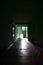 The blurred image of gloomy corridor of a neglected public building. Defocused picture of a public space in a poor residential hi