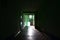 The blurred image of gloomy corridor of a neglected public building. Defocused picture of a public space in a poor residential hi