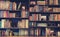 Blurred Image Many old books on bookshelf in library .