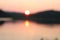 Blurred image. Sunset on a wide river. Pastel sunset colors. Summer landscape