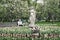 Blurred image of unrecognizable elderly man, pensioner, lonely resting in blooming spring park. Selective focus. Concept