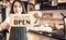 Blurred images of Coffee shop business owner, Asian woman Showing the opening sign