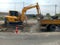 Blurred images, excavation of roads repaired using heavy machinery and human labor