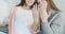 Blurred lesbian couple showing fingers with wedding rings at camera and hugging. Portrait of happy young Caucasian same