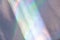 Blurred light rainbow holographic background with bright rays daylight