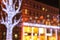 Blurred lights of the Christmas and New Year illuminations on the background of architecture, abstract bokeh, defocused