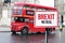 Blurred London street view with red double decker bus and Brexit no deal sign in rainy day. Possible exit of Great