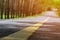 Blurred lonely road picture with warm sunlight. Empty barren natural places good for scenic drives with your free time or weekend