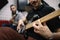 Blurred male guitarists playing guitars in studio