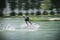 Blurred- Men athletes are playing Wakeboarding for X-Stream sports with daylight in beautiful blue lake,concept relaxing and