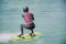 Blurred- Men athletes are playing Wakeboarding for X-Stream sports with daylight in beautiful blue lake,concept relaxing and