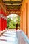 Blurred Monk Walks Past The Corridor Of A Buddhist Monastery. There Are Buddhist Scripts Written On The Ceiling