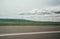 Blurred motion blur photo of autobahn railroad . Huge white clouds above