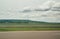 Blurred motion blur photo of autobahn railroad . Huge white clouds above