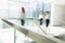 Blurred motion of businesswomen walking at office hallway