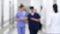 Blurred motion of doctors walking through corridor in hospital