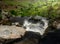 Blurred motion stream falls from top of waterfall of Pistyll Rhaeadr