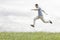 Blurred motion of young man jumping in park against sky