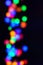 Blurred multicolored background image. Circles on a black background
