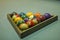 A blurred multicolored billiard balls on a blue table cloth in a wooden triangle. numbers on billiard balls
